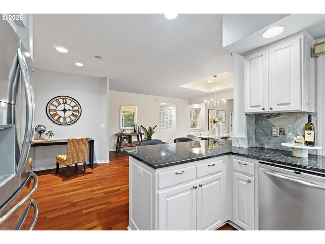 a kitchen with granite countertop a sink and cabinets
