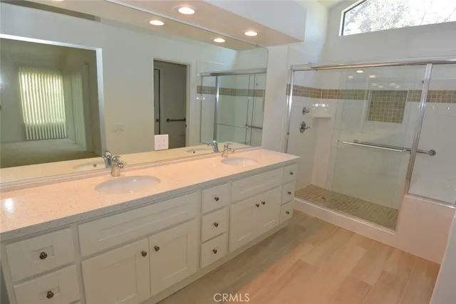 a bathroom with a shower sink and mirror