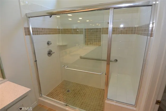 a bathroom with a shower and a sink