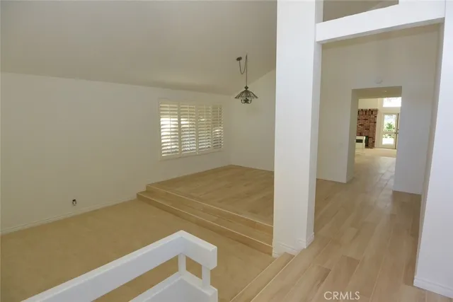 a view of an empty room and wooden floor