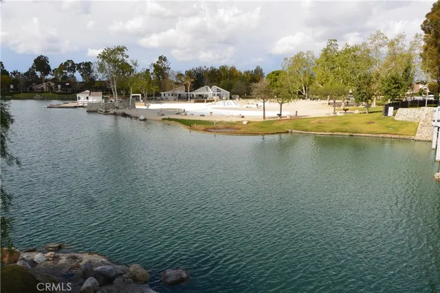 a view of a water with boats and trees in the background