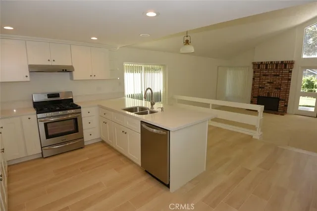 a kitchen with granite countertop a stove and a sink