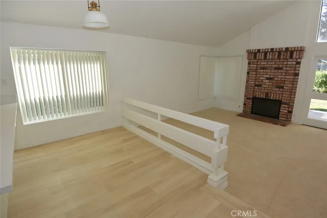 a view of an empty room with a fireplace