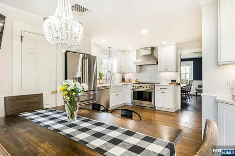 a kitchen with refrigerator and cabinets