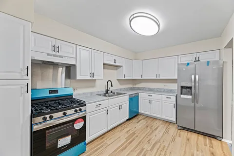 a kitchen with a stove a sink and a refrigerator