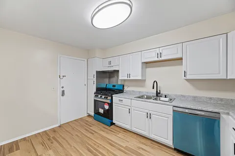 a kitchen with stainless steel appliances a sink stove and refrigerator
