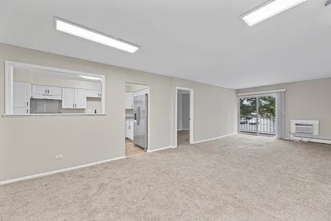 a view of a livingroom with an empty space and a window