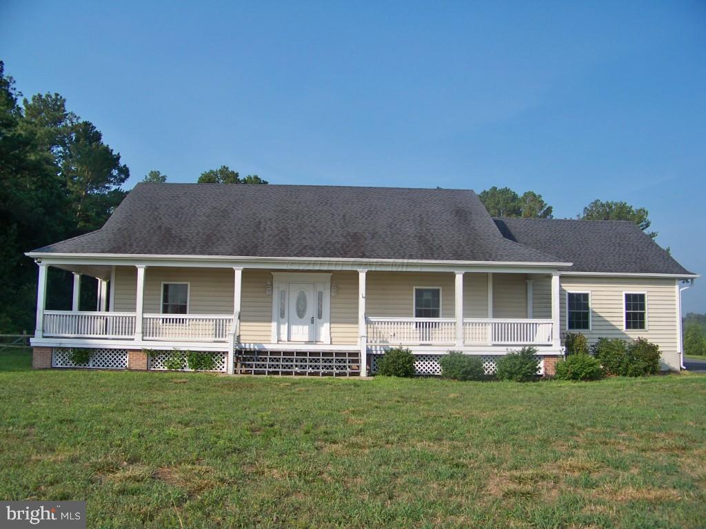 6658 Friendship Road Pittsville, MD 21850 - Photo 1 of 11 front view of a house with a yard