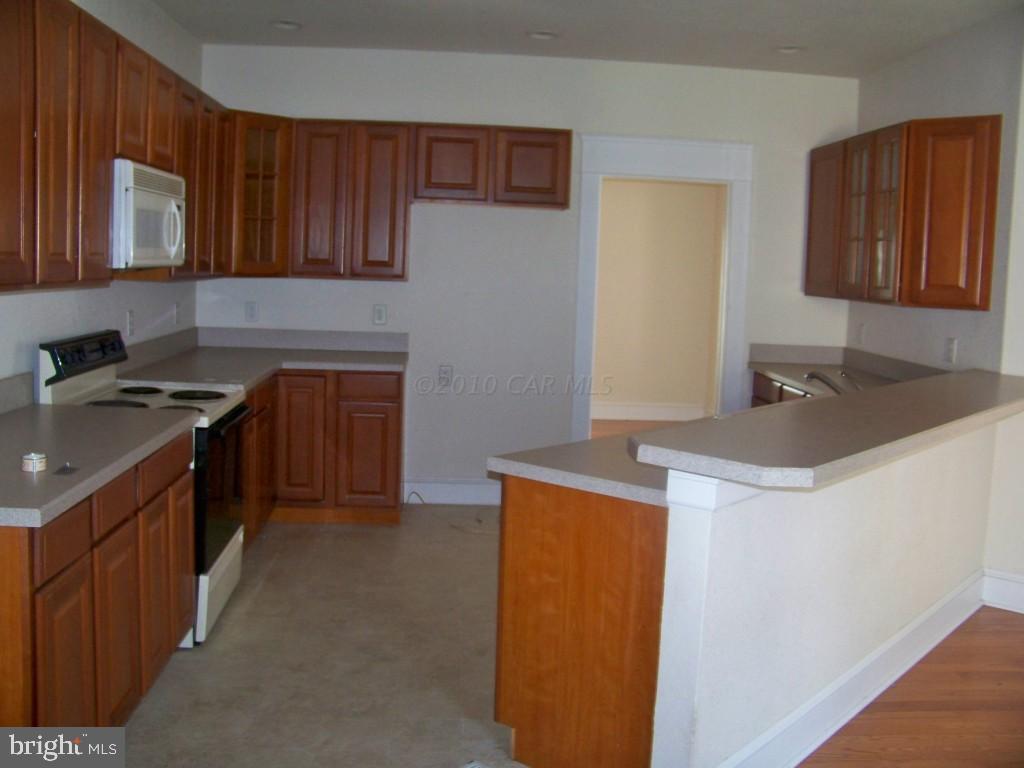 6658 Friendship Road Pittsville, MD 21850 - Photo 2 of 11 a kitchen with stainless steel appliances granite countertop a sink stove and cabinets