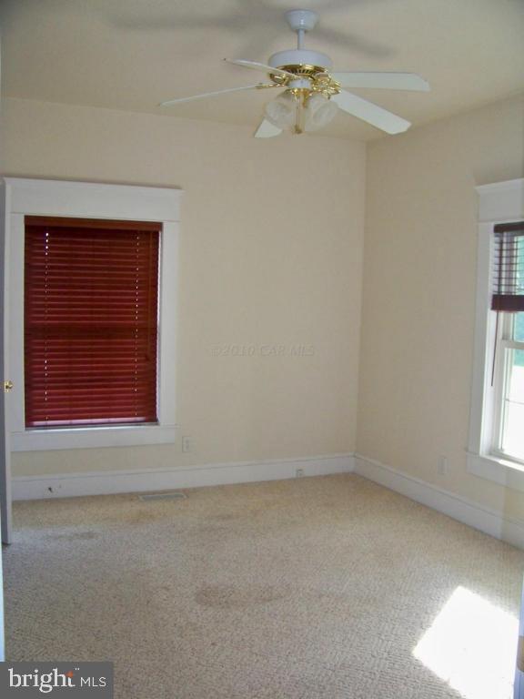 6658 Friendship Road Pittsville, MD 21850 - Photo 11 of 11 an empty room with windows and cabinet