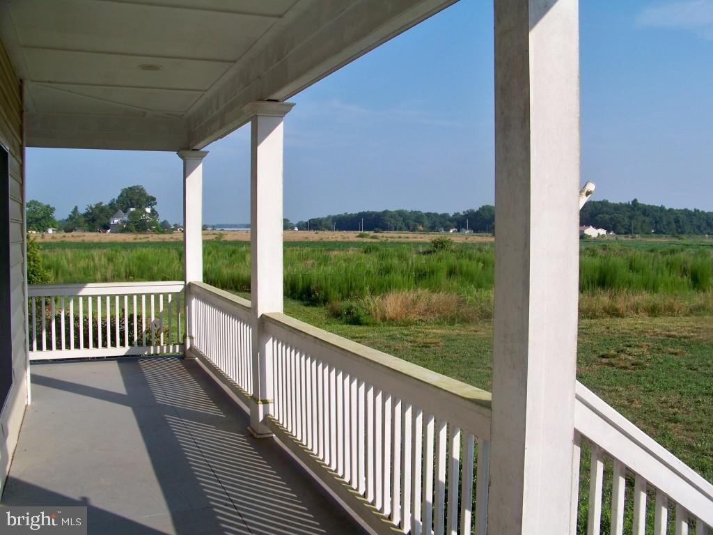 6658 Friendship Road Pittsville, MD 21850 - Photo 9 of 11 a view of a porch with a yard