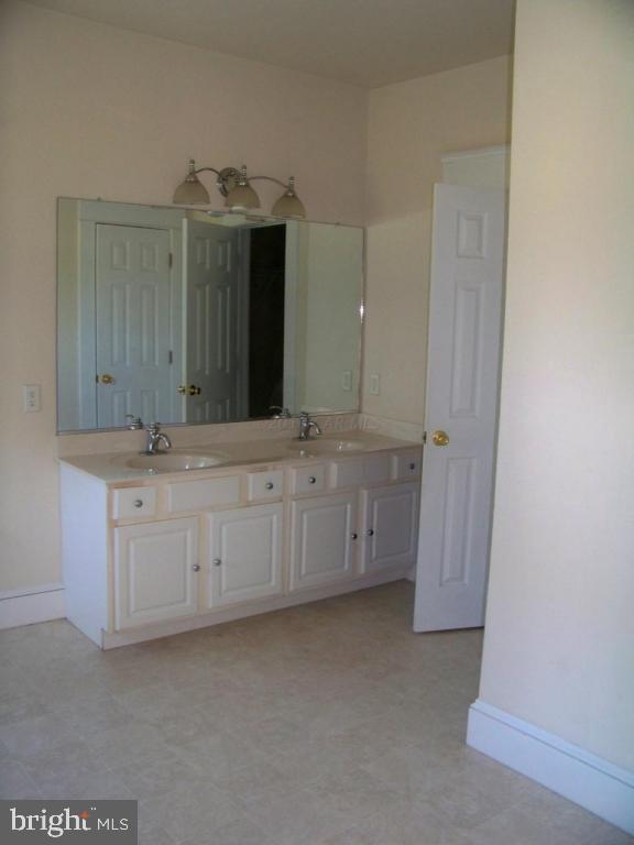 6658 Friendship Road Pittsville, MD 21850 - Photo 10 of 11 a bathroom with a granite countertop sink and a mirror