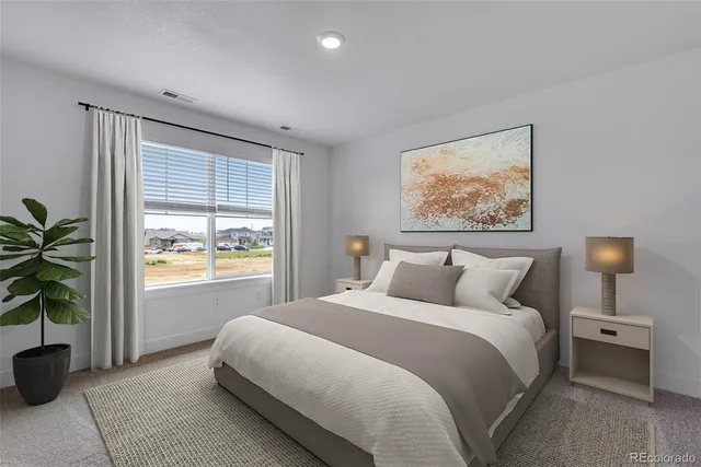 a bedroom with a large bed and a window