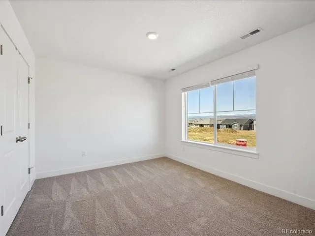 a view of an empty room and a window