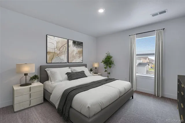 a bedroom with a large bed and a window