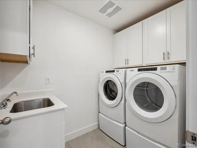a utility room with sink dryer and washer
