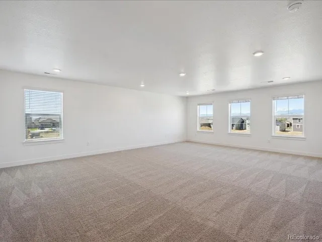 an empty room with a empty space and windows