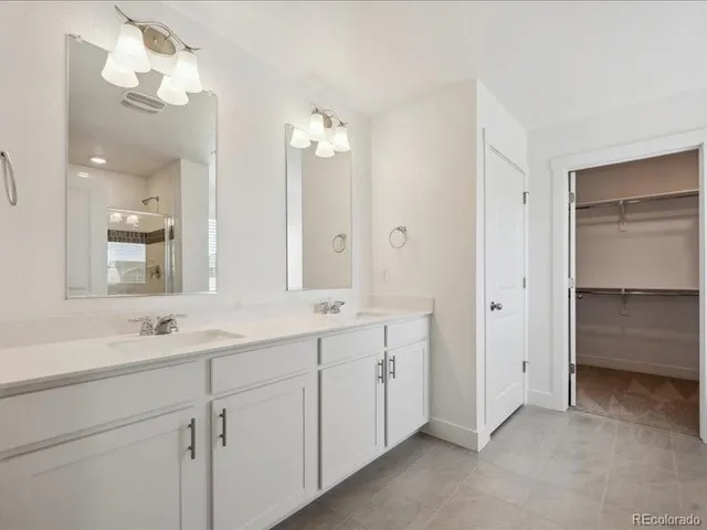 a bathroom with a double vanity sink mirror and a