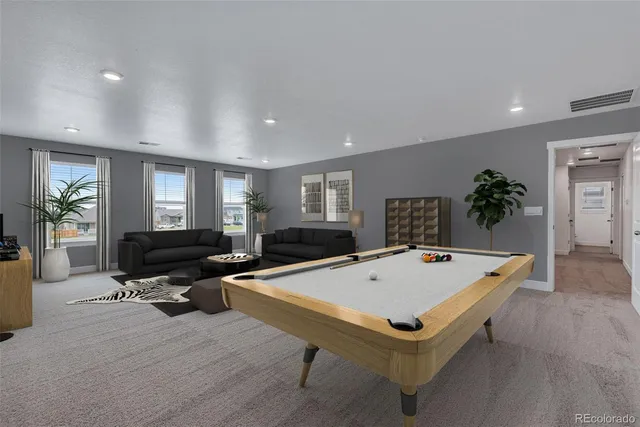 a living room with furniture pool table and flat screen tv