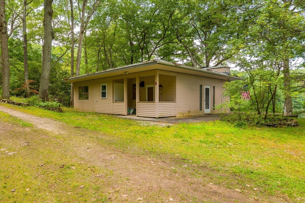 1 Cormack Road Sturbridge, MA 01566 - Photo 22 of 28 a front view of a house with yard and green space