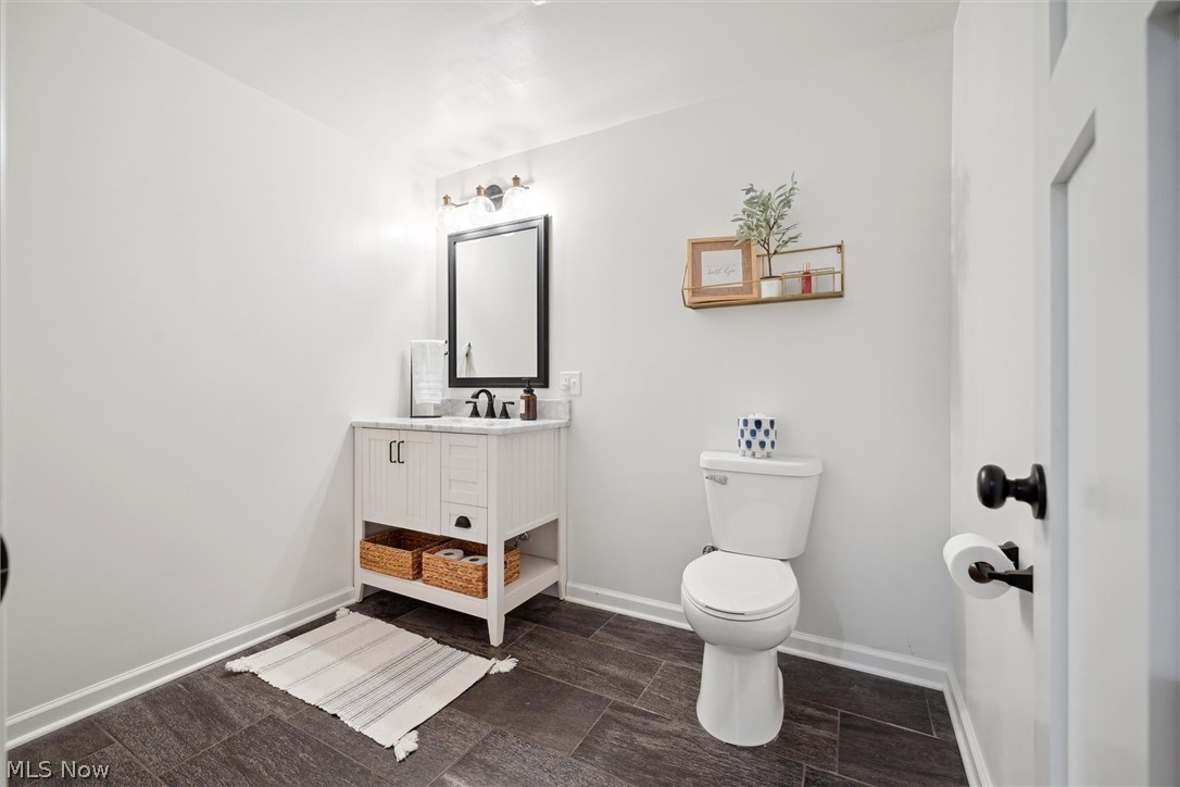 405 East Luchsinger Road Port Clinton, OH 43452 - Photo 32 of 40 Bathroom featuring toilet, vanity, and tile flooring