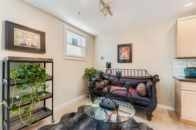 a living room with furniture and a potted plant