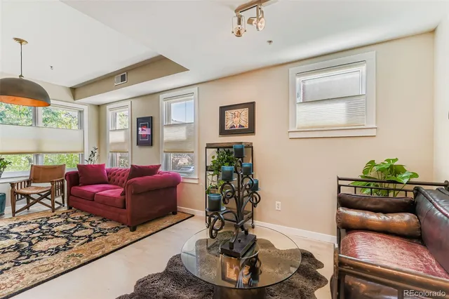 a living room with furniture flowerpot and a window