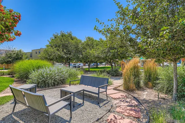 a backyard of a house with table and chairs