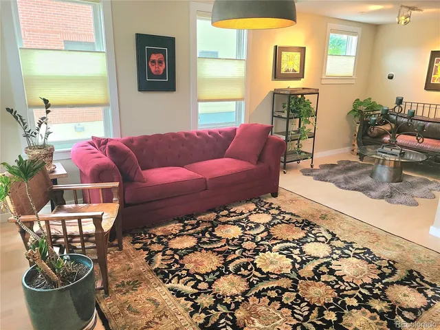 a living room with furniture and a potted plant