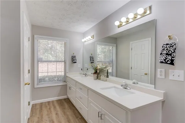 a bathroom with a sink double vanity granite and a mirror