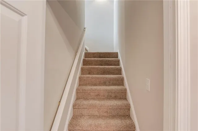 a view of staircase with white walls