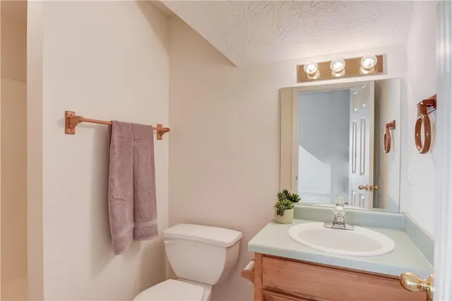 a bathroom with a sink toilet and mirror