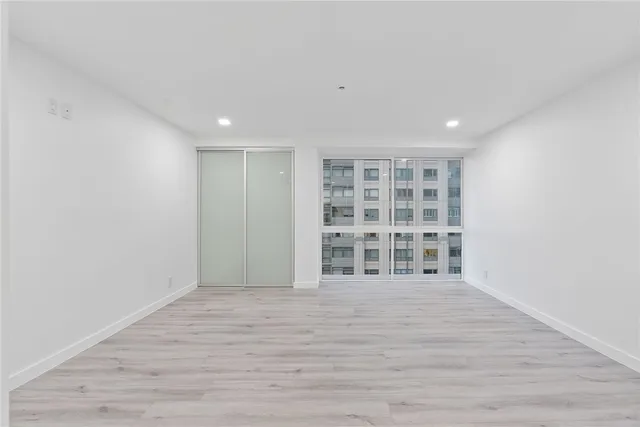 a bathroom with a glass shower door and mirror