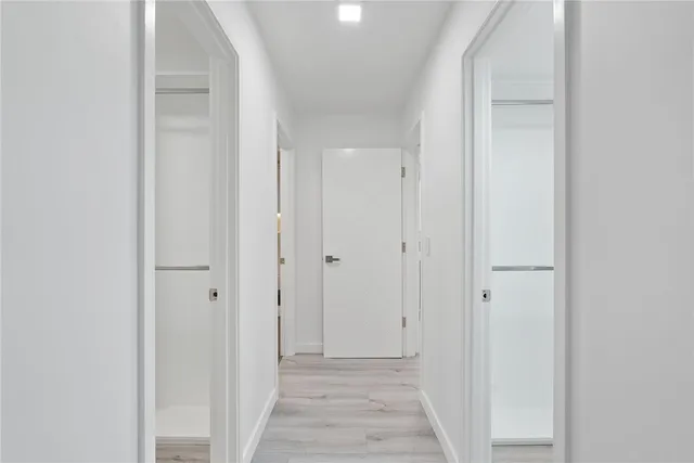 a large kitchen with stainless steel appliances kitchen island granite countertop a large counter top and wooden floors