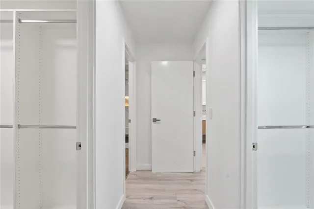 a view of an empty room with a wooden floor