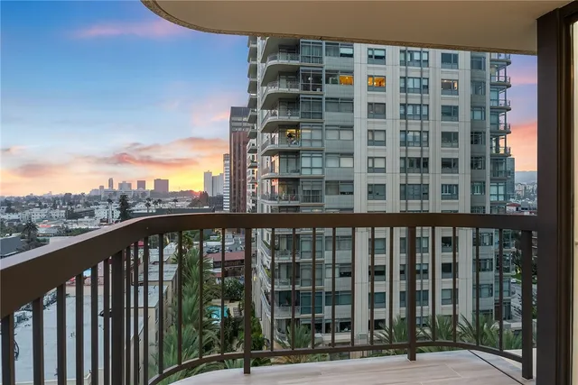 a view of an empty room with glass door and windows