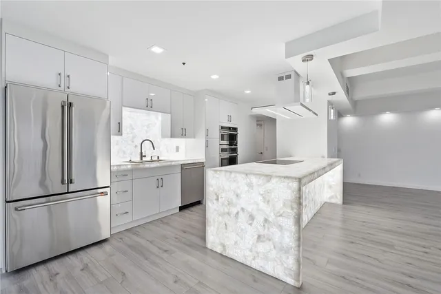 a kitchen with granite countertop a sink and a stove