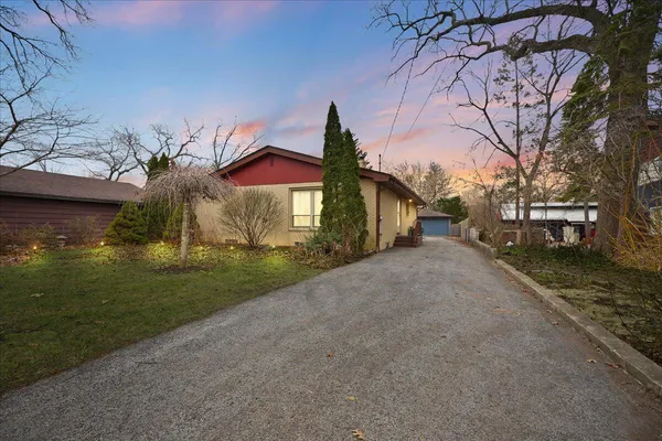 a front view of a house with garden