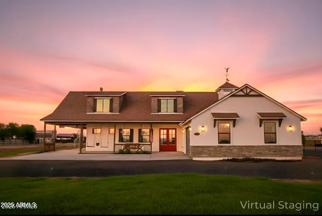 a front view of a house with a garden and yard