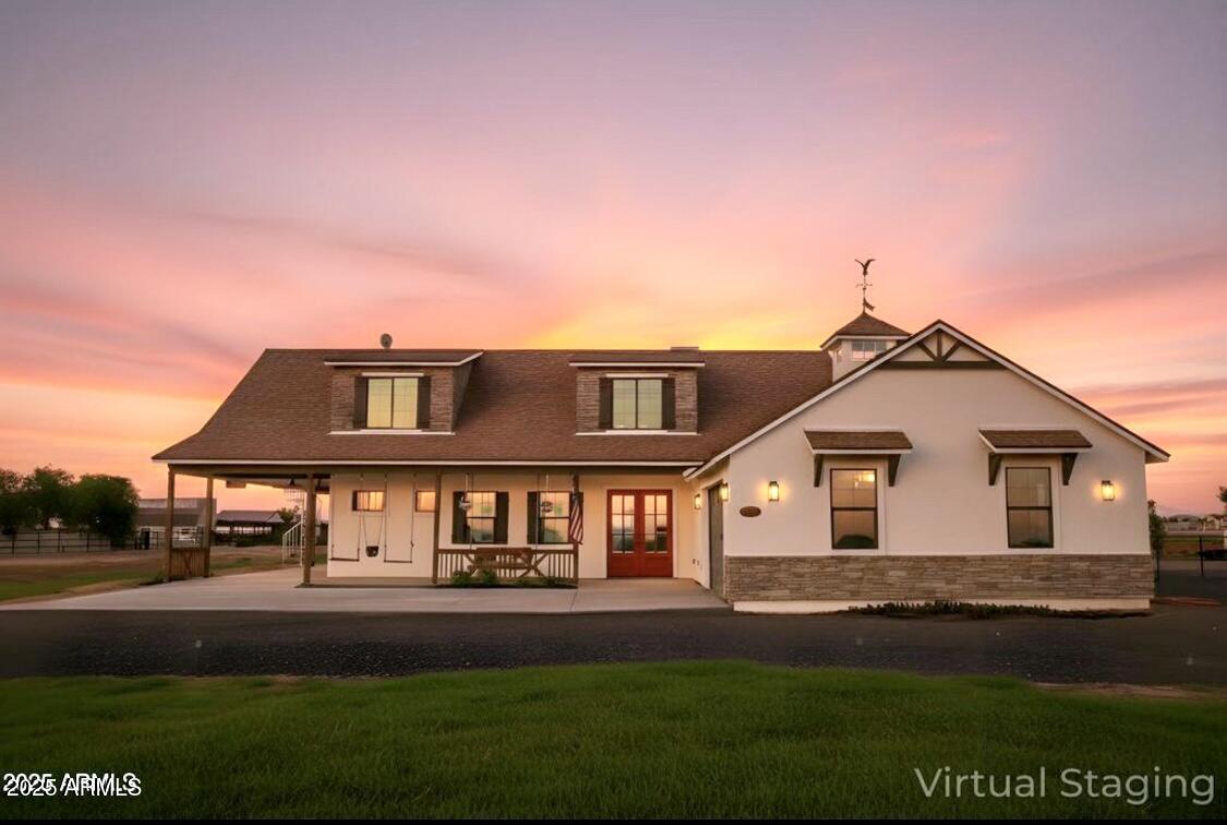 a front view of a house with a garden and yard