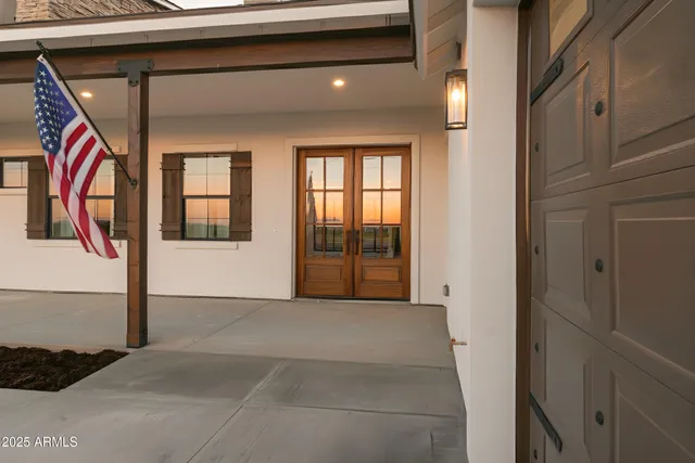 a backyard of a house with barbeque oven and brick wall