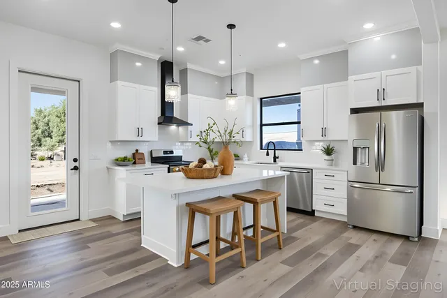 a living room with furniture a chandelier fan and a rug