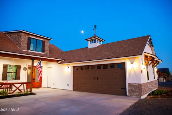 a backyard of a house with barbeque oven and brick wall