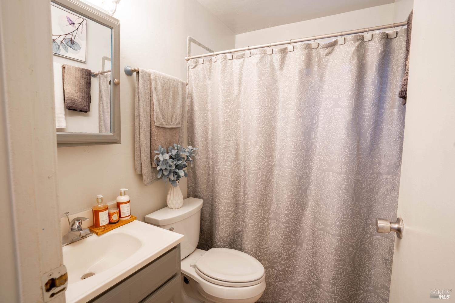 237 Del Loma Court Fairfield, CA 94533 - Photo 11 of 15 a white toilet sitting next to a bathroom sink