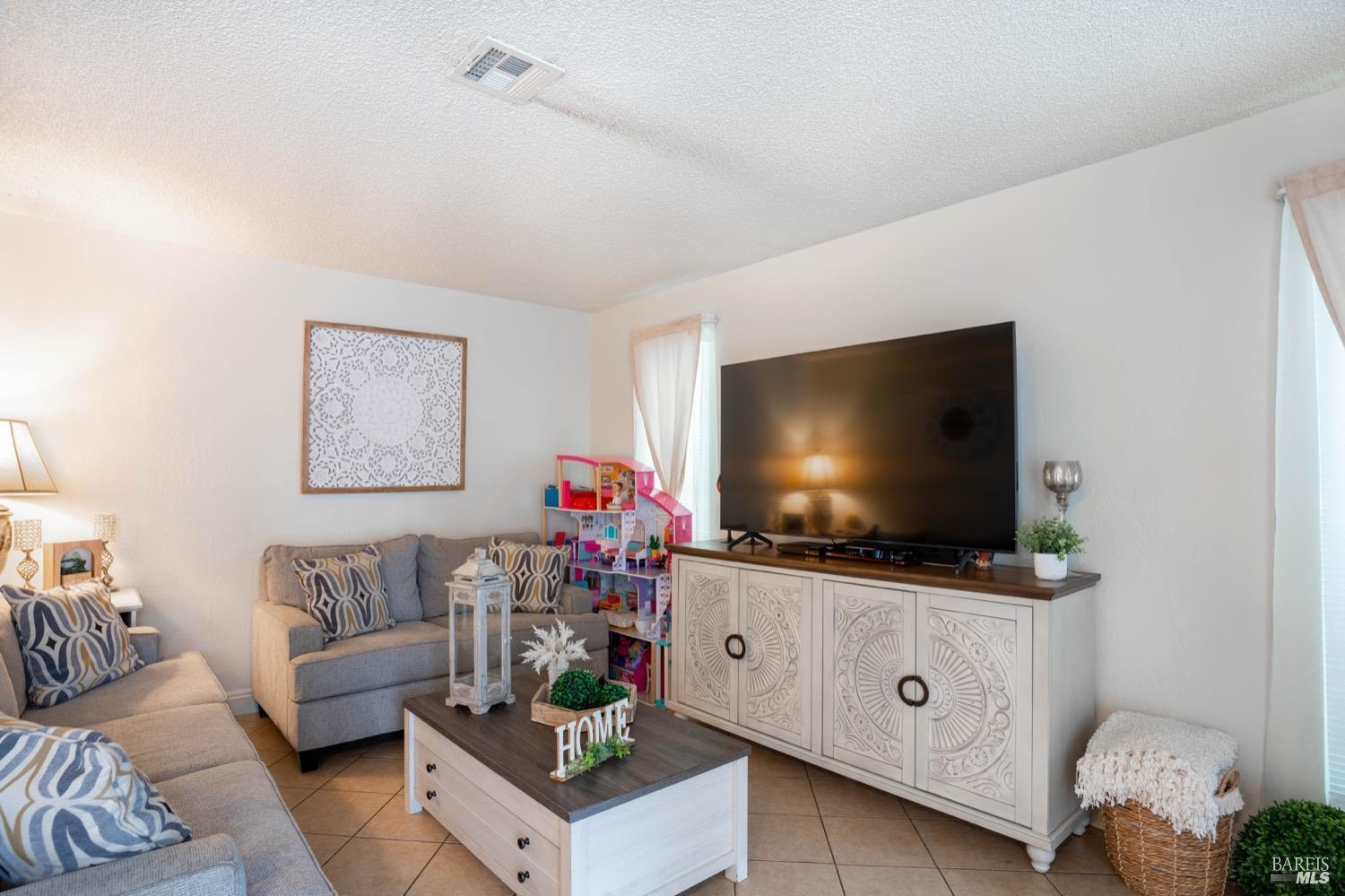 237 Del Loma Court Fairfield, CA 94533 - Photo 5 of 15 a living room with furniture and a flat screen tv