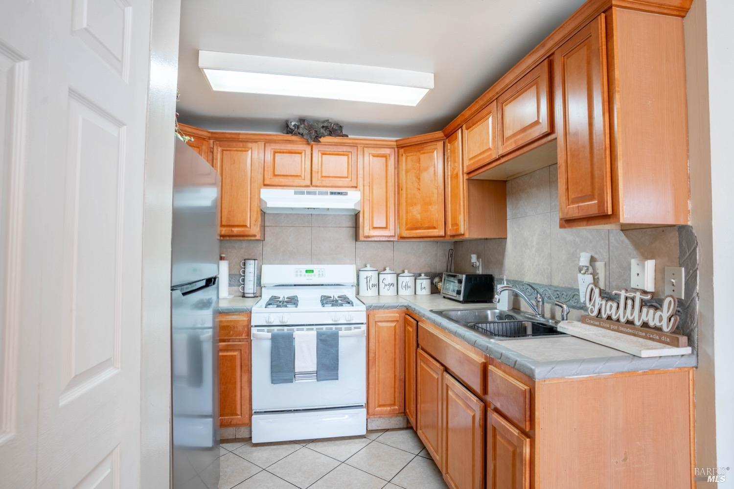 237 Del Loma Court Fairfield, CA 94533 - Photo 6 of 15 a kitchen with stainless steel appliances granite countertop a sink stove and refrigerator