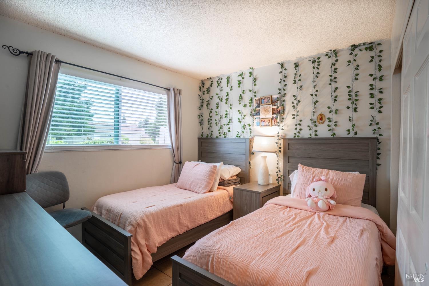 237 Del Loma Court Fairfield, CA 94533 - Photo 10 of 15 a bedroom with two beds and a large window