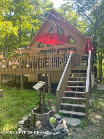 a view of a patio with table and chairs potted plants