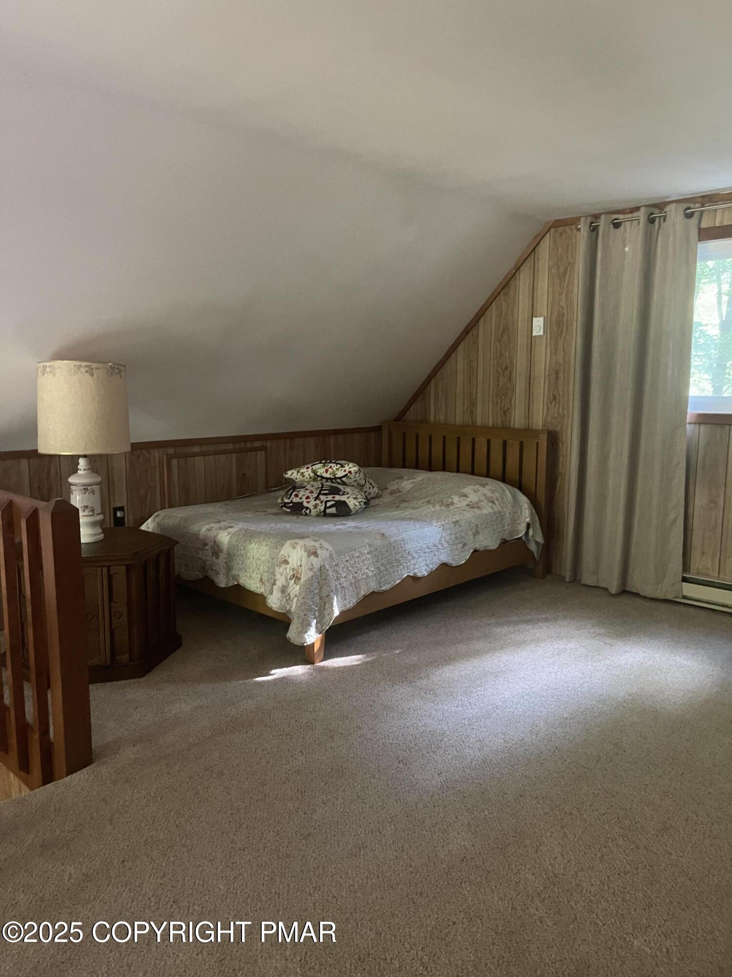 2112 Eagle Path Bushkill, PA 18324 - Photo 11 of 14 a spacious bedroom with a bed and a chandelier
