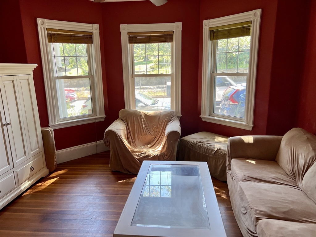 765 Boylston Street, Unit 1 Brookline, MA 02467 - Photo 11 of 12 a living room with furniture and a window